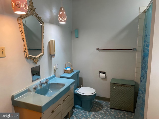 full bath with tile patterned flooring, vanity, and toilet