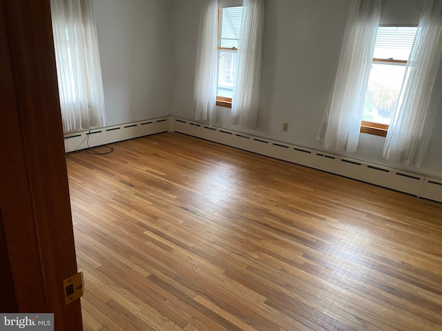 spare room with wood-type flooring