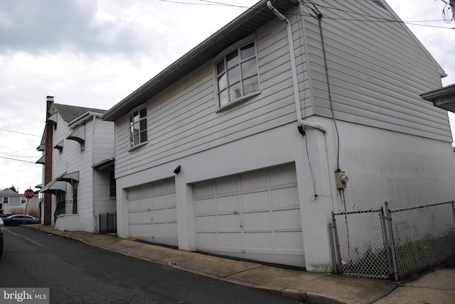 view of side of property featuring a garage