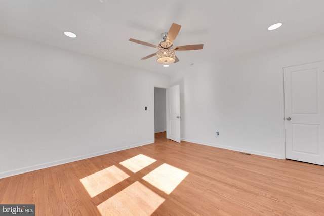 spare room with recessed lighting, light wood-style flooring, baseboards, and ceiling fan