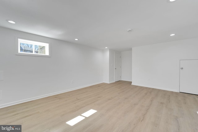 basement with recessed lighting, baseboards, and light wood-style floors