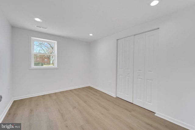 unfurnished bedroom featuring recessed lighting, baseboards, and wood finished floors