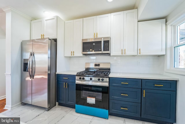 kitchen featuring blue cabinets, stainless steel appliances, light countertops, and white cabinetry