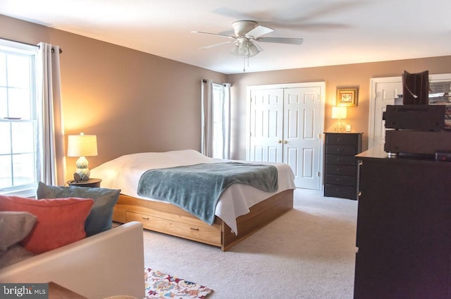 bedroom featuring carpet, ceiling fan, and a closet