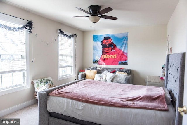 bedroom featuring ceiling fan, multiple windows, carpet flooring, and baseboards