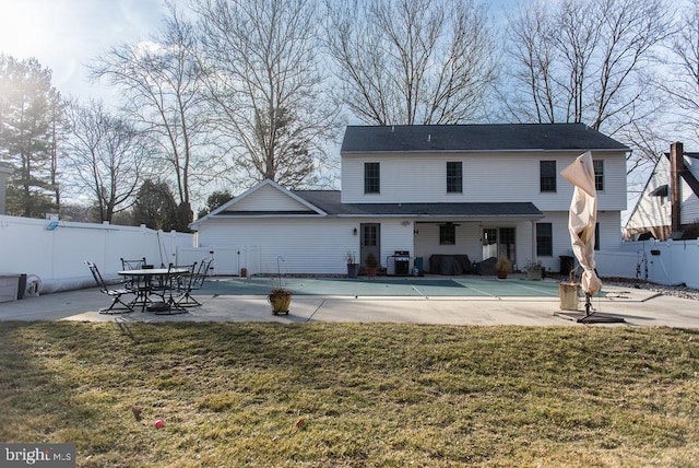 back of house with a patio area, a yard, and a fenced backyard