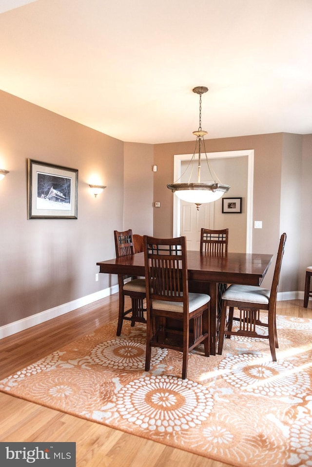 dining area with wood finished floors and baseboards