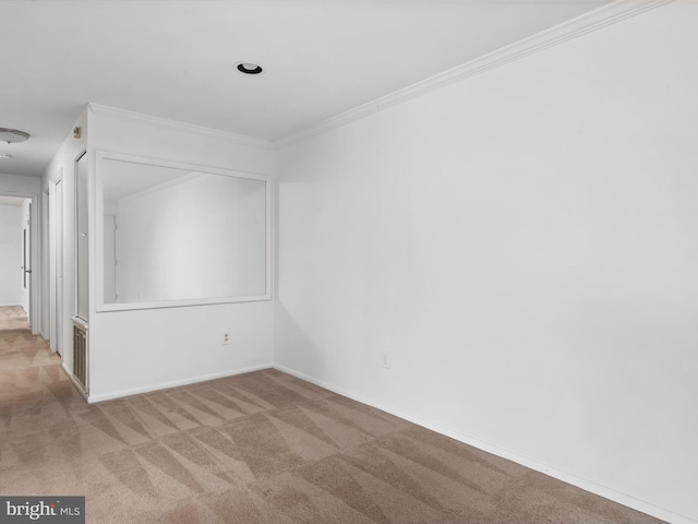 empty room featuring baseboards, ornamental molding, and carpet flooring