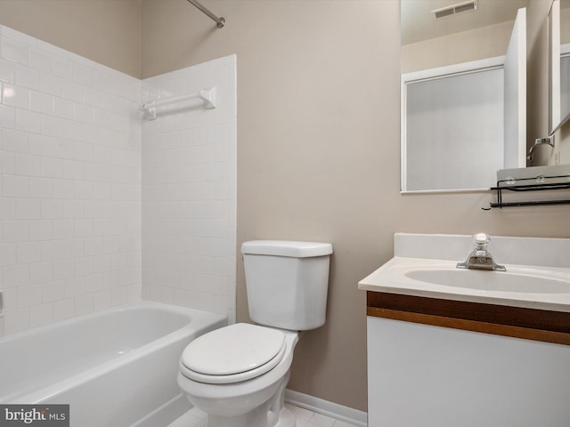 bathroom featuring tile patterned flooring, toilet, vanity, visible vents, and baseboards