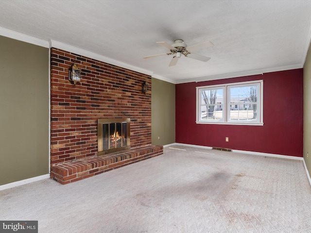 unfurnished living room with visible vents, a brick fireplace, crown molding, and baseboards