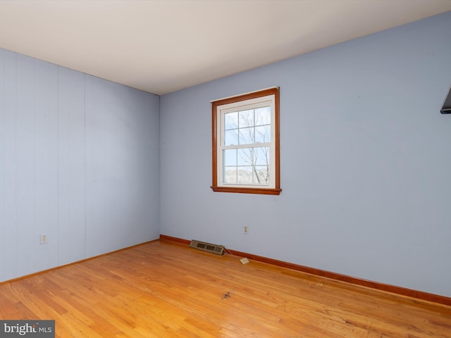 unfurnished room with visible vents, baseboards, and light wood-style floors