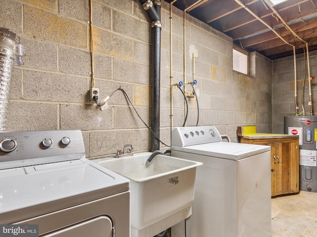 laundry area featuring a sink, electric water heater, laundry area, and washer and clothes dryer