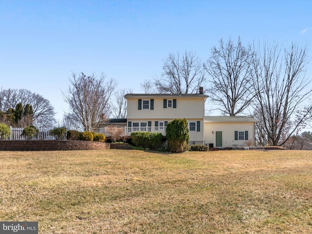 view of front of property with a chimney and a front lawn