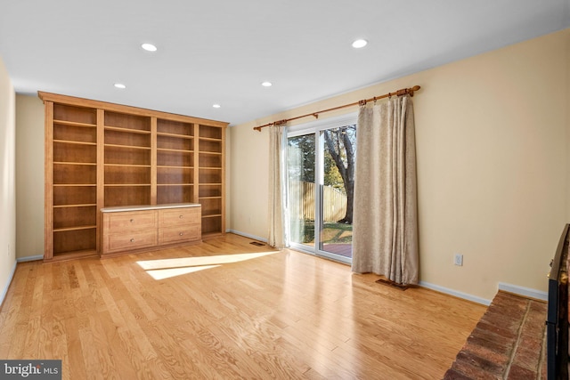 unfurnished living room featuring recessed lighting, baseboards, and light wood finished floors