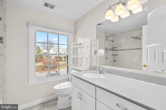 bathroom with visible vents, toilet, tile patterned flooring, tiled shower, and vanity