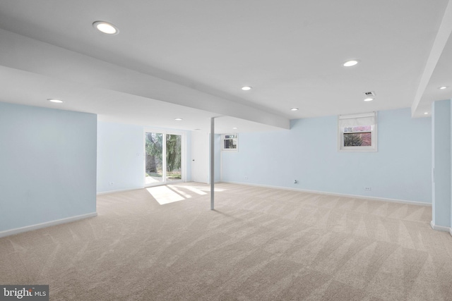 basement with recessed lighting, light colored carpet, and baseboards