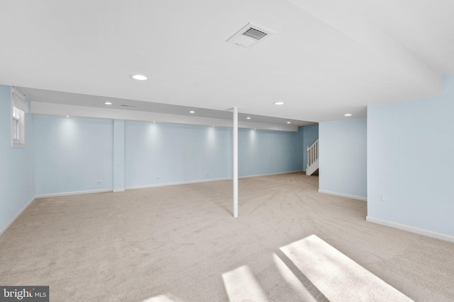 finished basement featuring carpet, visible vents, baseboards, recessed lighting, and stairs