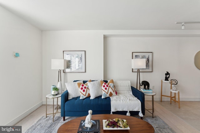 living room featuring light wood-type flooring and baseboards