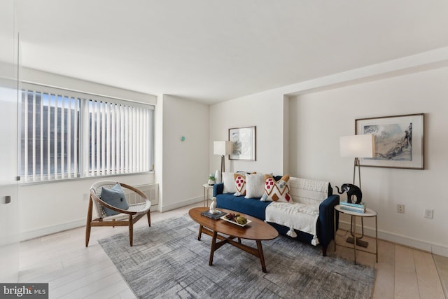 living area with wood finished floors and baseboards