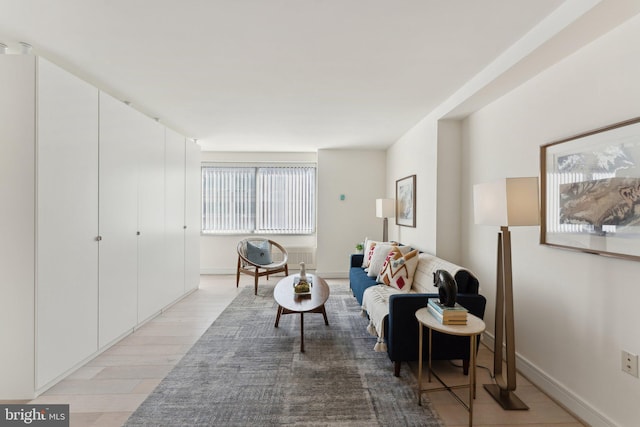 living room featuring light wood-style flooring and baseboards