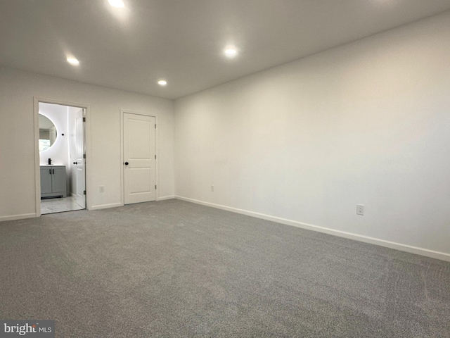 empty room featuring baseboards, carpet flooring, and recessed lighting