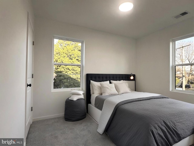 carpeted bedroom with baseboards and visible vents