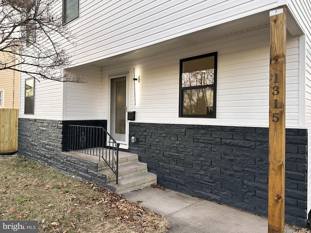 doorway to property featuring stone siding