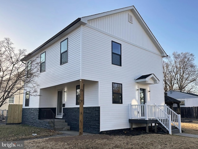 view of front of house featuring fence