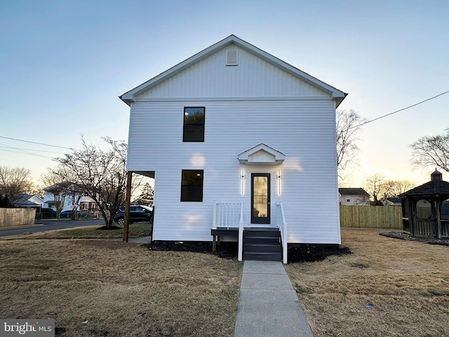 view of front of house featuring fence