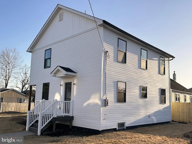 back of house featuring fence