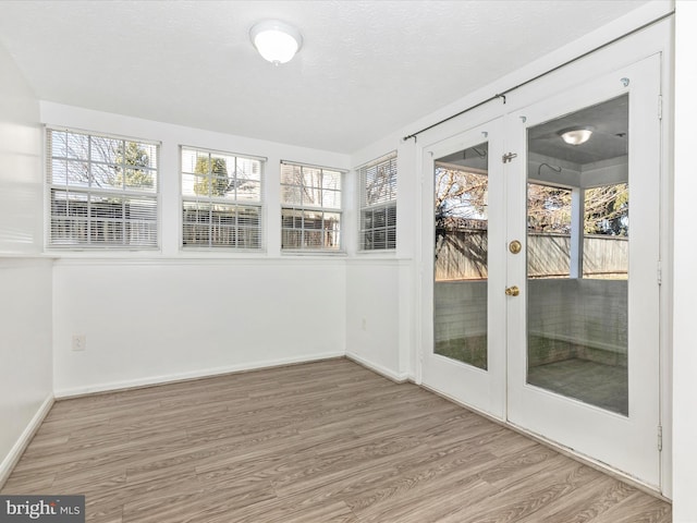 unfurnished sunroom featuring french doors