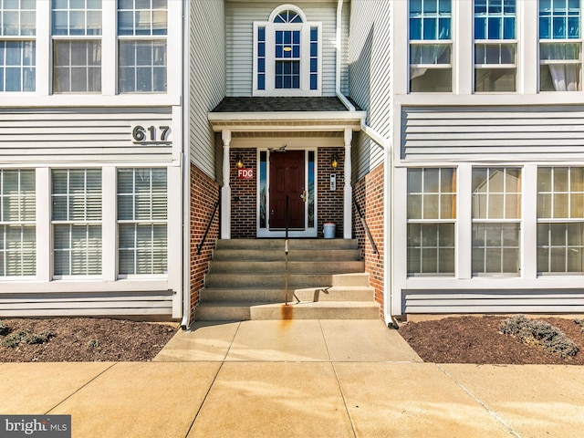 property entrance with brick siding