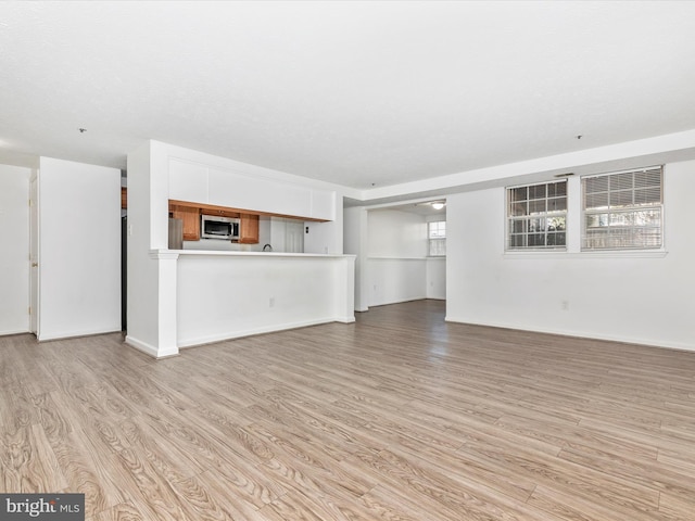 unfurnished living room featuring light wood-type flooring