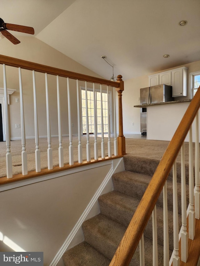 stairway with baseboards, recessed lighting, a ceiling fan, and lofted ceiling