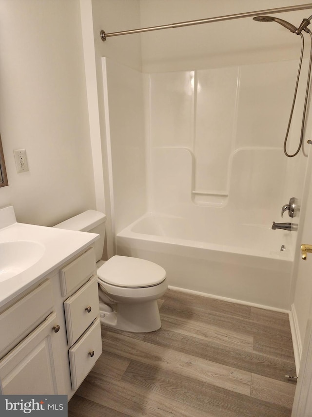 full bathroom with toilet, vanity, bathtub / shower combination, and wood finished floors