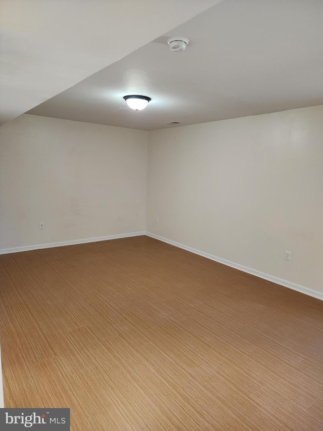 spare room with baseboards