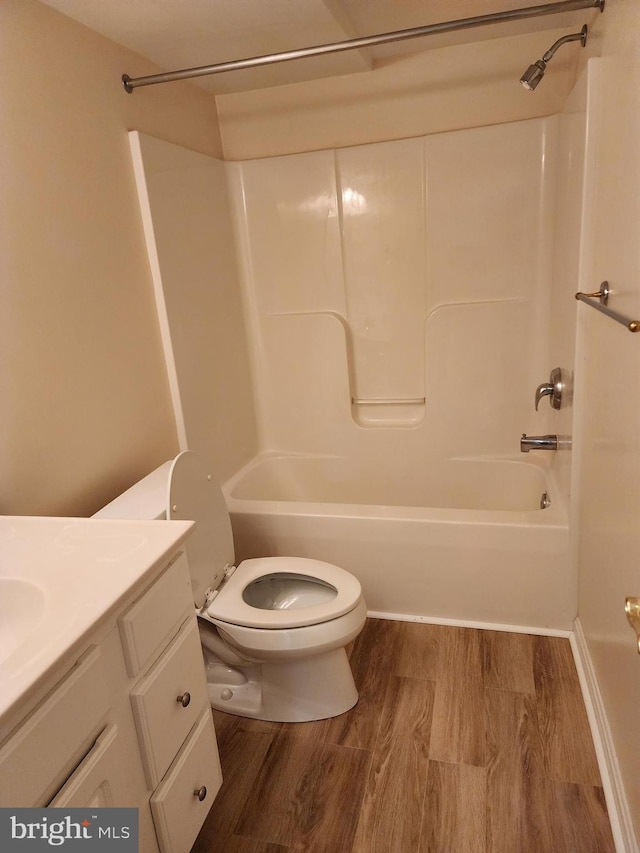 full bath featuring vanity, toilet, shower / bathtub combination, and wood finished floors