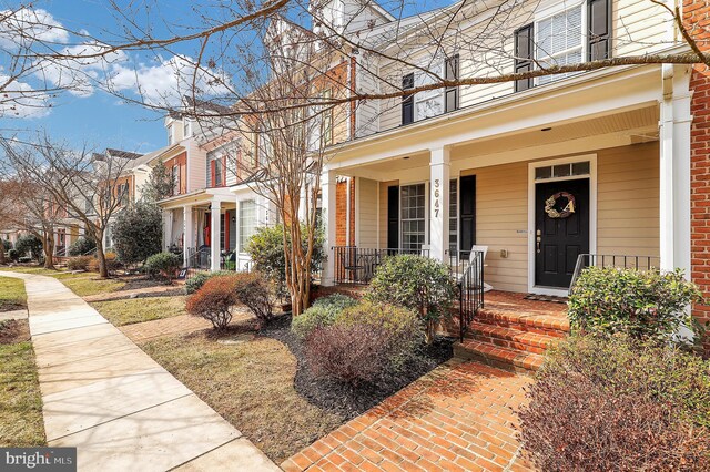 view of front facade featuring a residential view, a porch, and a balcony