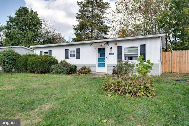 single story home featuring fence and a front yard