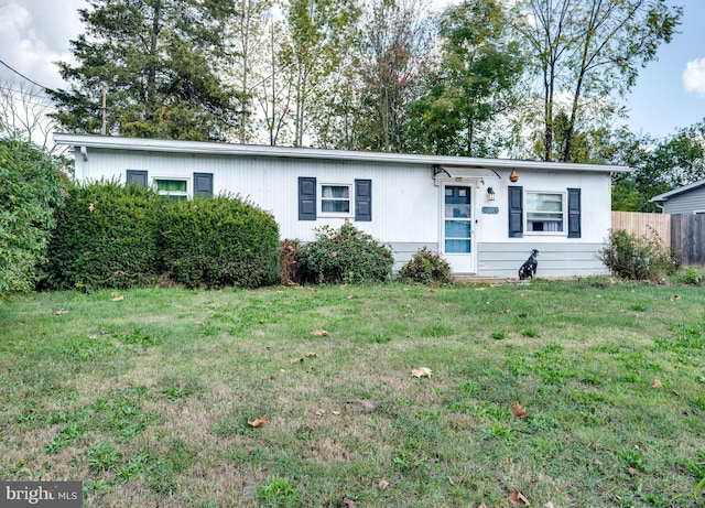 single story home with fence and a front yard