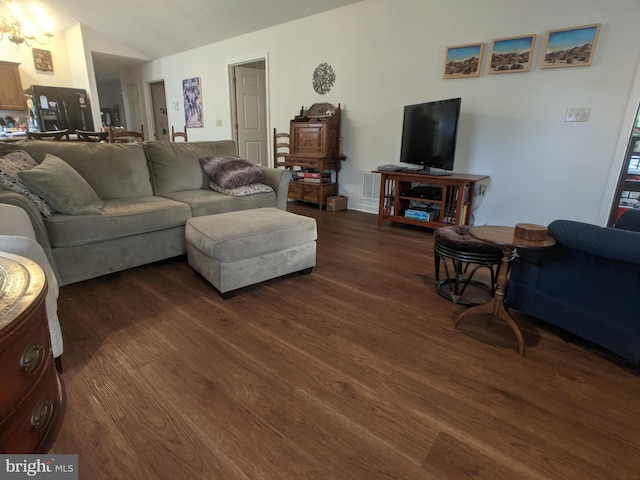 living room with vaulted ceiling and wood finished floors