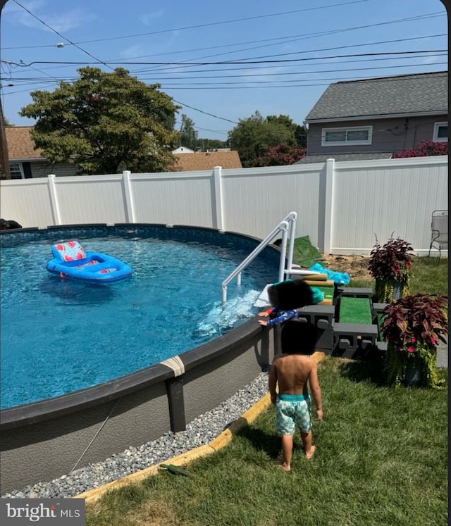 view of swimming pool featuring a fenced backyard and a fenced in pool