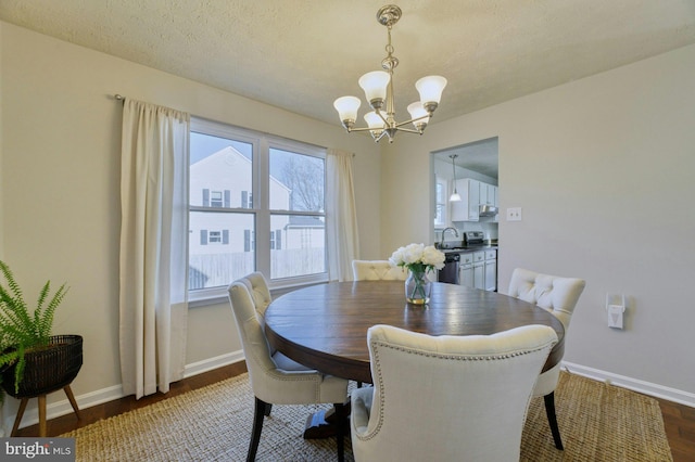 dining space with baseboards, dark wood-type flooring, and a chandelier