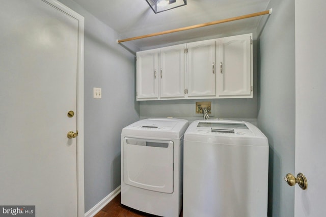 clothes washing area with washer and dryer, cabinet space, dark wood finished floors, and baseboards