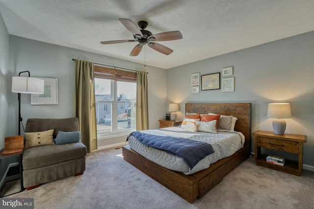 carpeted bedroom with ceiling fan and baseboards