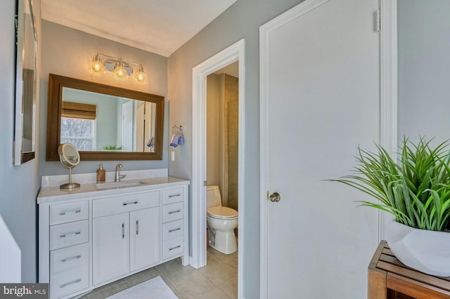 bathroom with tile patterned flooring, toilet, and vanity