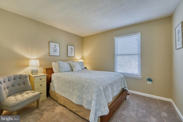 bedroom featuring light colored carpet and baseboards