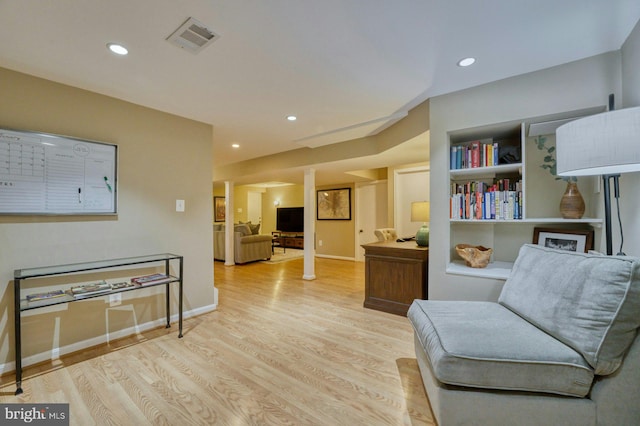 living area with recessed lighting, wood finished floors, visible vents, and baseboards