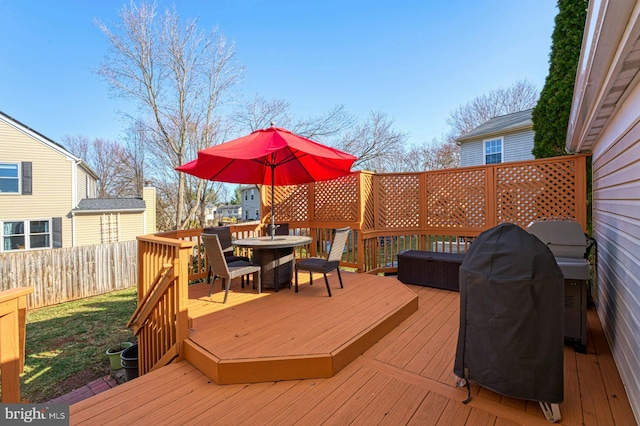 deck with outdoor dining area and fence