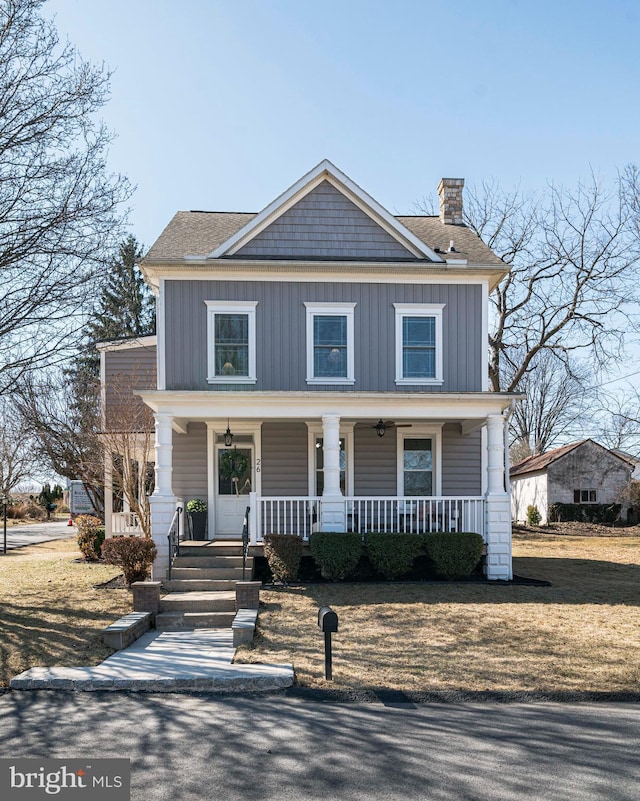 traditional style home with covered porch, board and batten siding, and a chimney